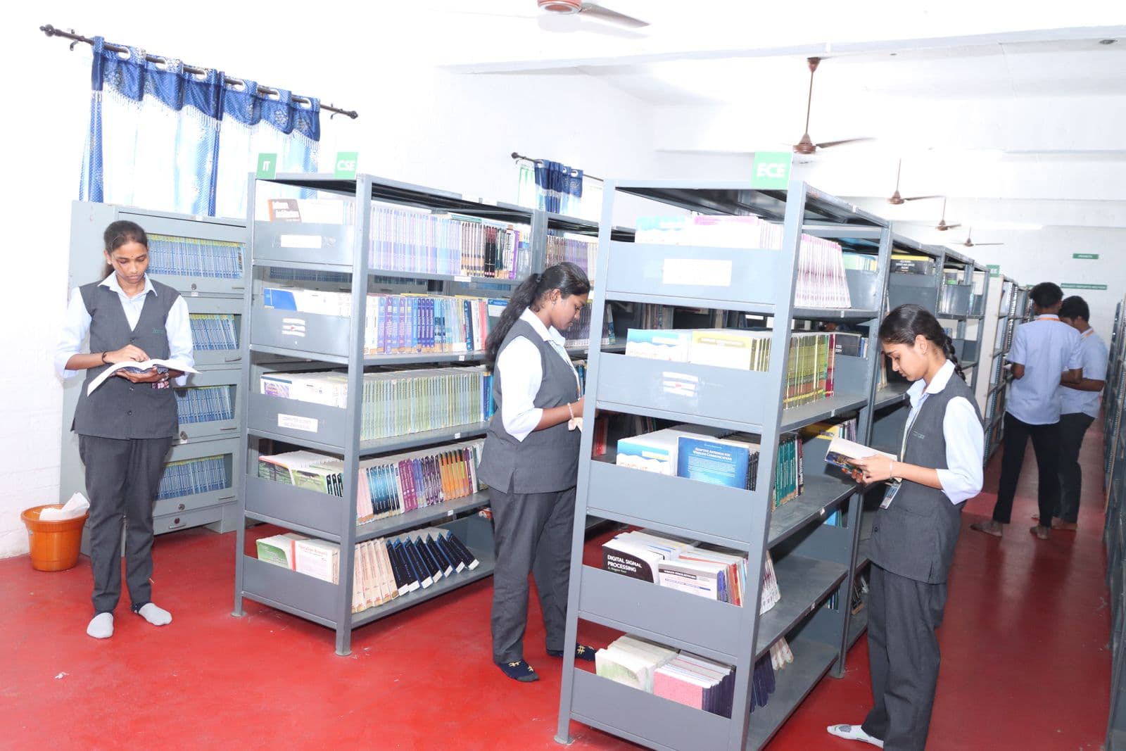 Learners browsing books in the library